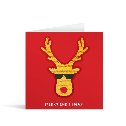 Red square greetings card with gold shiny sequin Rudolph wearing sunglasses and fun, free-flowing text that reads "Merry Christmas!"