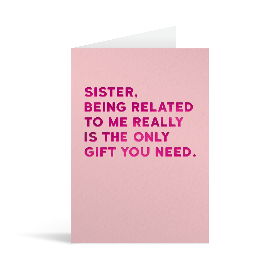 Pastel pink rectangular card with fuschia foiled text saying "Sister, being related to me really is the only gift you need."