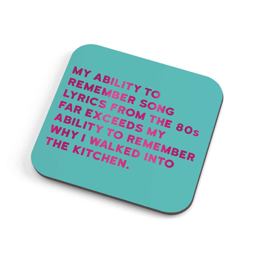 A funny (colour) coaster with fuschia foiled text saying: "My ability to remember song lyrics from the 80's far exceeds my ability to remember why I walked into the kitchen."