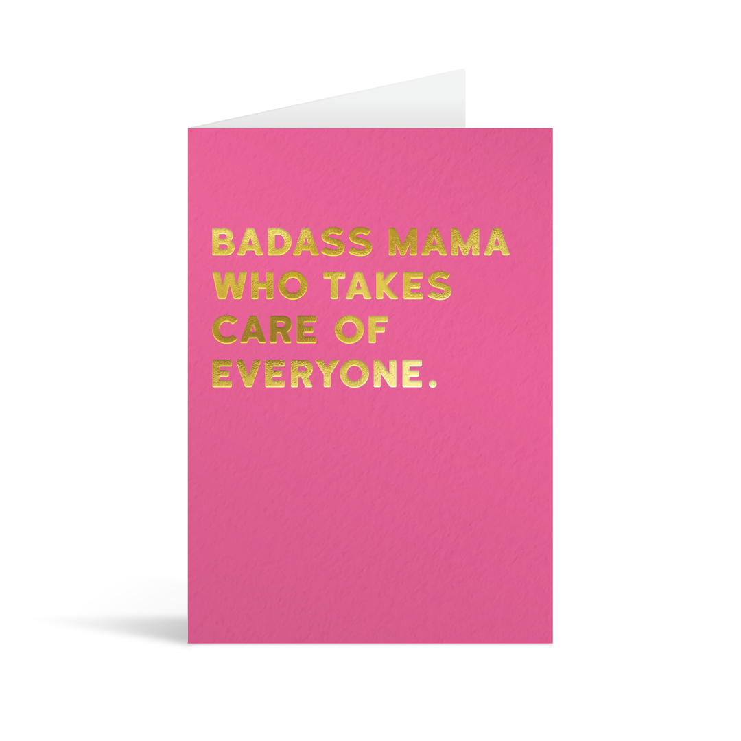 Pink card with gold foiled text that reads "Badass mama who takes care of everyone."