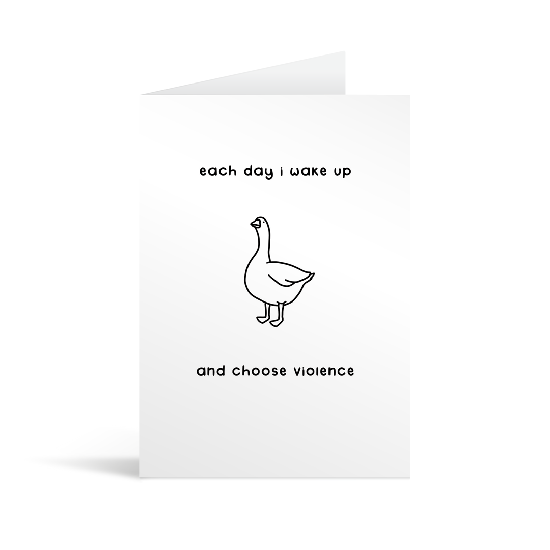 A rectangular white card with a cartoon illustration of a goose and the words "Each day I wake up and choose violence. Lime green envelope in the background.
