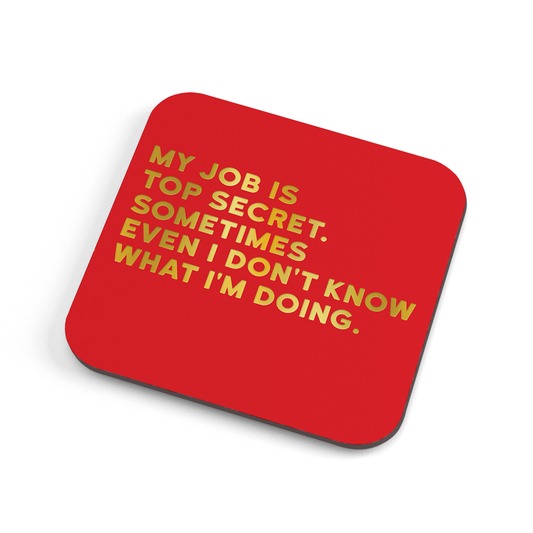 A funny red coaster with gold foiled text saying: "My job is top secret. Sometimes even I don't know what I'm doing."