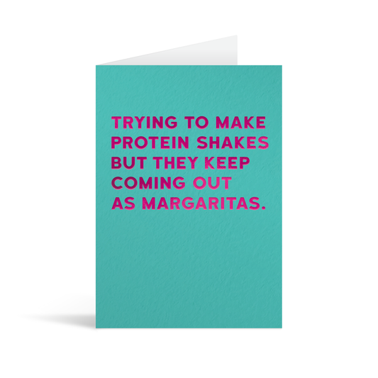 Turquoise rectangular card with fuschia foiled text saying: "Trying to make protein shakes but they keep coming out as margaritas."