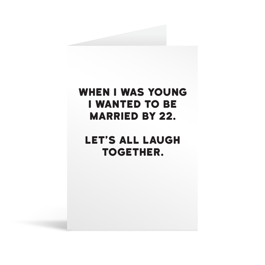 White rectangular card with funny black text saying: "When I was young I wanted to be married by 22. Let's all laugh together."
