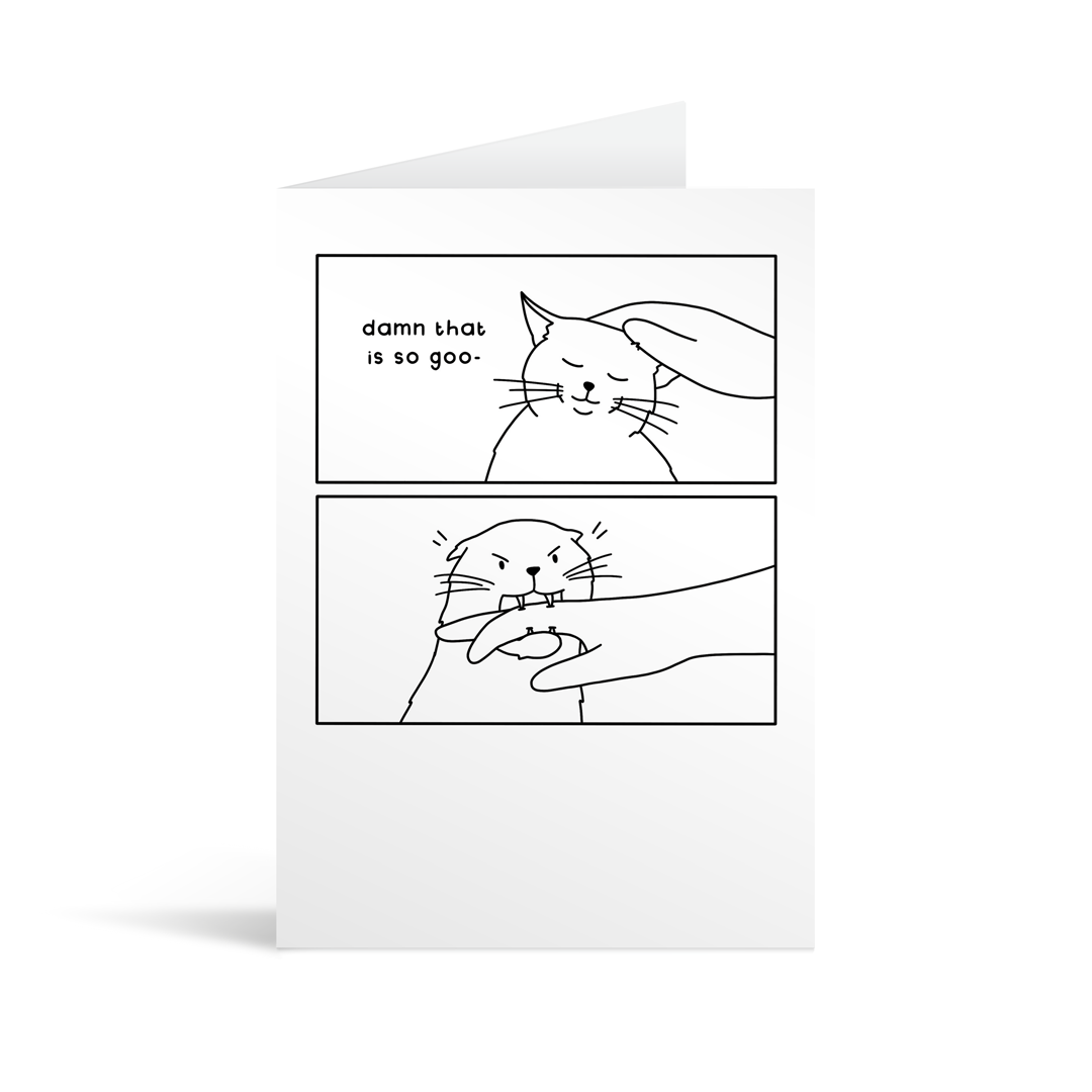 A rectangular white card with a cartoon illustration depicting a man stroking a cat, and the cat biting him. Lime green envelope in the background.
