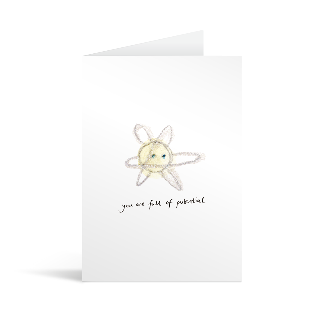 White rectangular card with hand illustrated atom above handwriting that reads "you are full of potential"