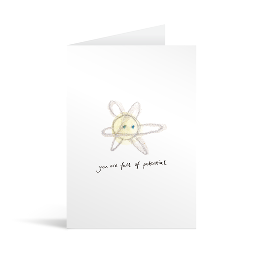White rectangular card with hand illustrated atom above handwriting that reads "you are full of potential"