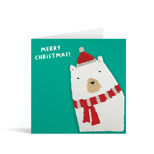 Turquoise square greetings card with reversible sequin polar bear patch and fun, free-flowing text that reads "Merry Christmas!"