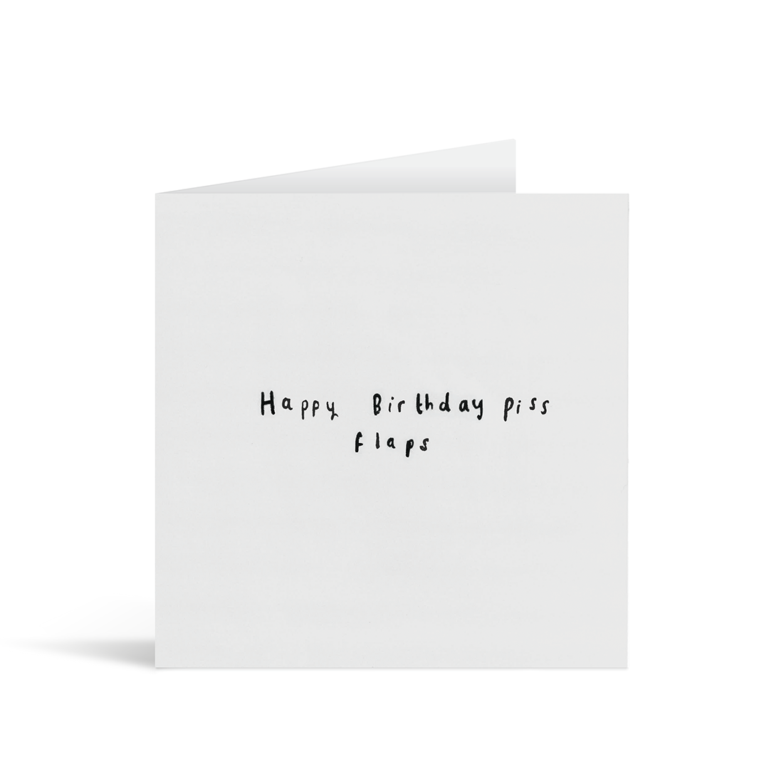 A textured grey card with the handwritten words "Happy Birthday piss flaps"