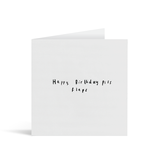 A textured grey card with the handwritten words "Happy Birthday piss flaps"