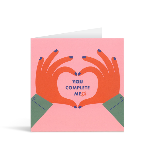 Funny and contemporary pink card of two colourful hands making a heart shape inside which there is the text "You complete mess"