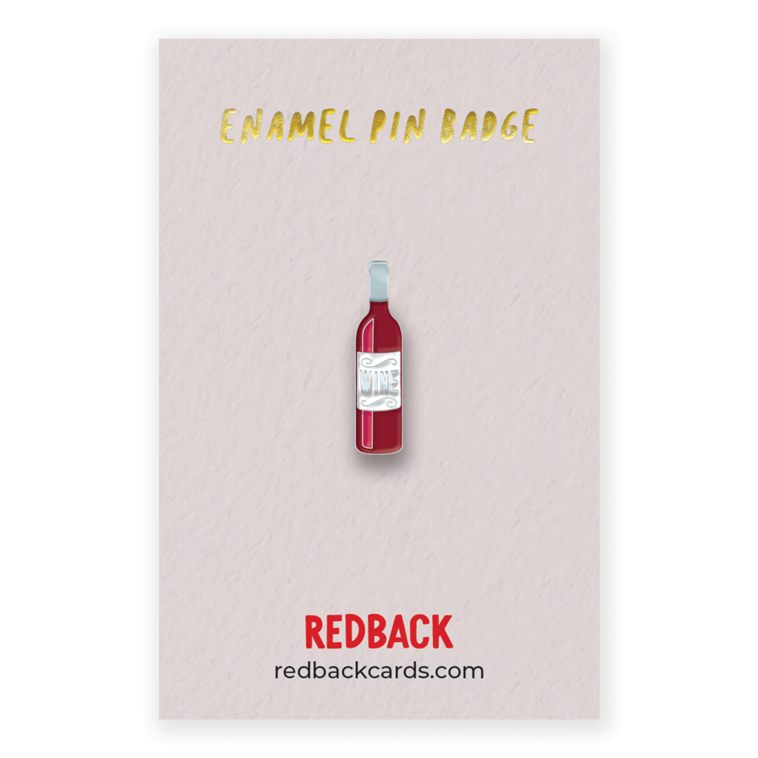 A funny red wine bottle enamel pin, with wine written across the centre of the pin. Mounted on card