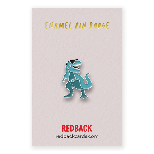 A cool blue dinosaur wearing sunglasses enamel pin with silver detailing. Mounted on card