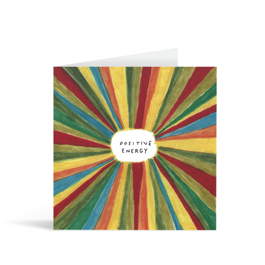 A square arty card with a colourful starbust painting radiating from the central handwritten words "positive energy"