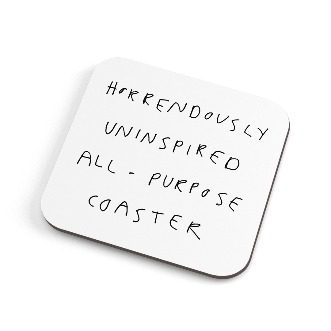 A white funny handwritten-style coaster with balck text saying: Horrendously uninspired all-purpose coaster."