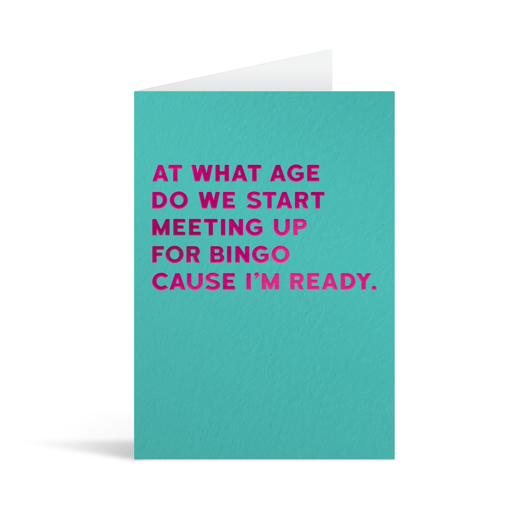 Teal rectangular card with fuscia foiled text reading "At what age are we meeting up for bingo cause I'm ready".