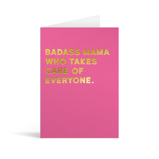 Pink card with gold foiled text that reads "Badass mama who takes care of everyone."