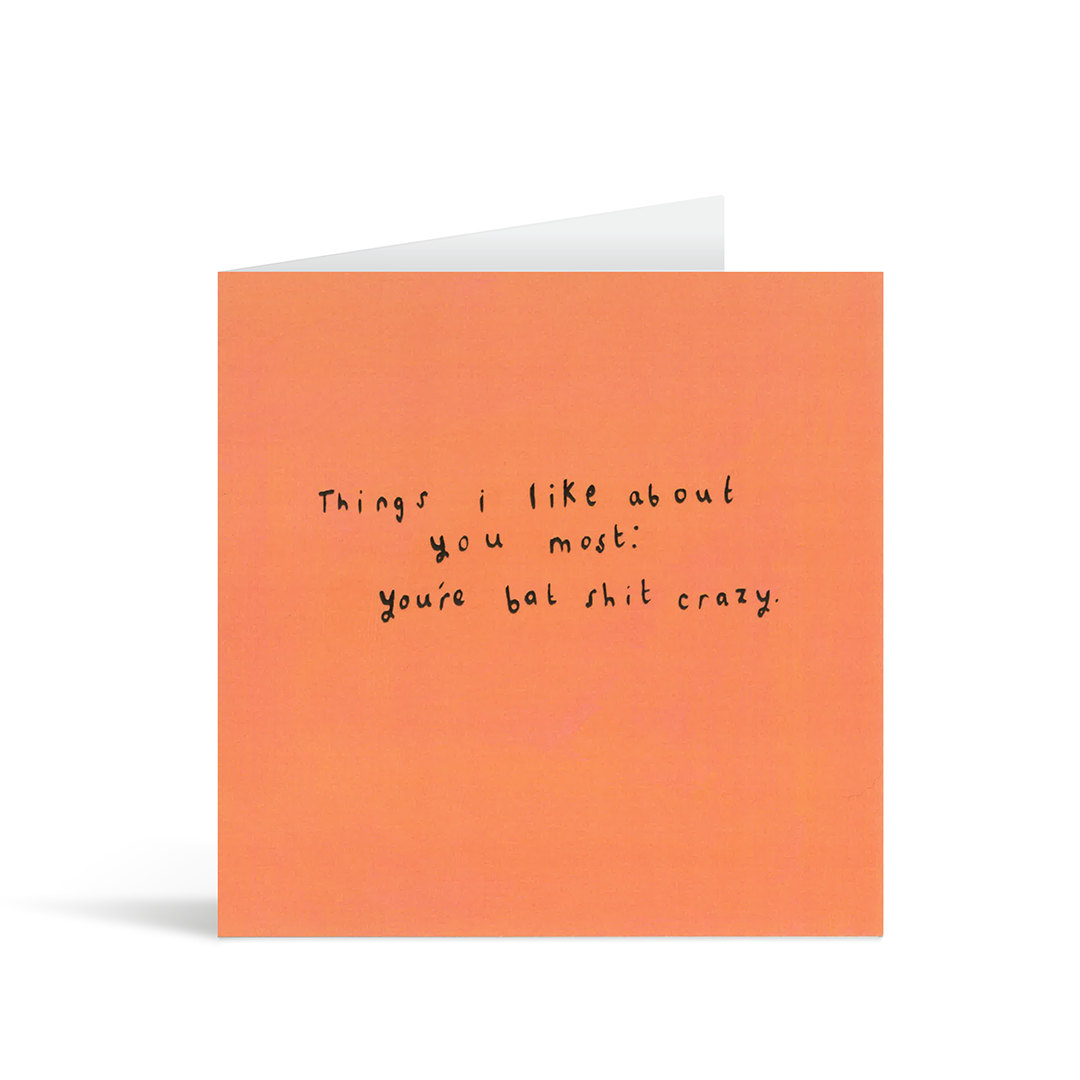 A textured orange card with the handwritten text "Things I like about you most: you're bat shit crazy."