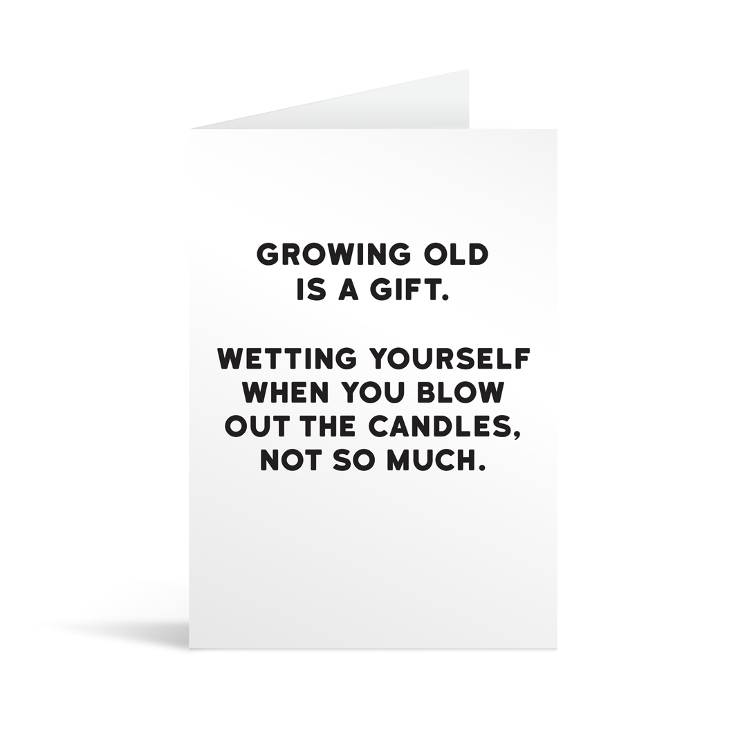 White rectangular card with black text saying: " Growing old is a gift. Wetting yourself when you blow out the candles, not so much."