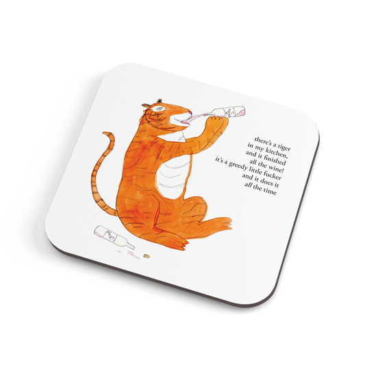 A funny hand illustrated coaster with a tiger drinking wine on it, saying "there's a tiger in the kitchen, and it's finished all the wine! It's a greedy little fucker and it does it all the time."