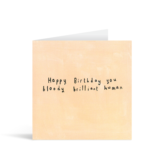 A textured pale orange card with the handwritten words "Happy Birthday you bloody brilliant human"