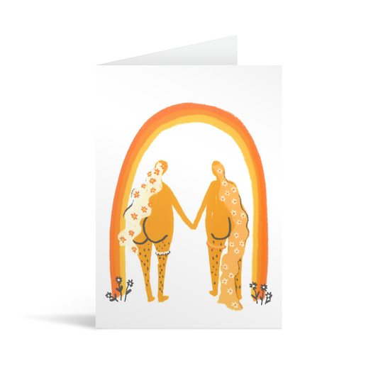 Wedding card with an autumnal rainbow under which are standing a naked couple painted from behind, with cute bottoms. Both are women and have flowing long hair, one wears a garter.