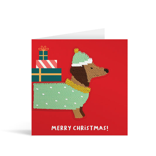 Red square greetings card with colourful reversible sequin sausage dog patch and fun, free-flowing text that reads "Merry Christmas!"