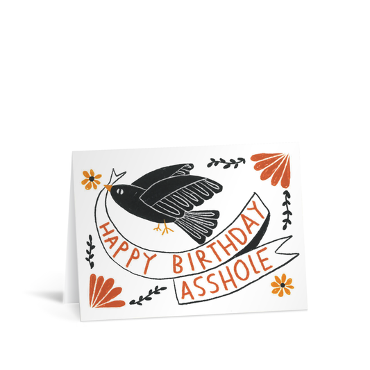 A contemporary card with a beautiful hand illustration of a stylised black bird, carrying a banner in its beak that reads "Happy Birthday Asshole"