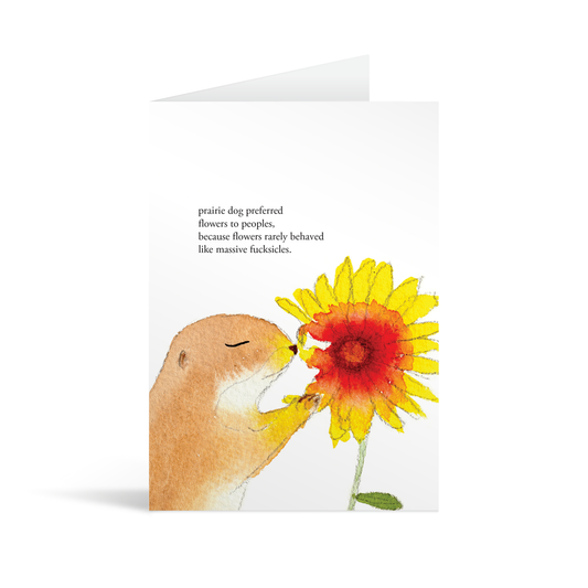 A white rectangular card with a cute dog sniffing a sunflower and funny text saying "'Prairie dog preferred flowers to people, because flowers rarely behaved like massive fucksicles"