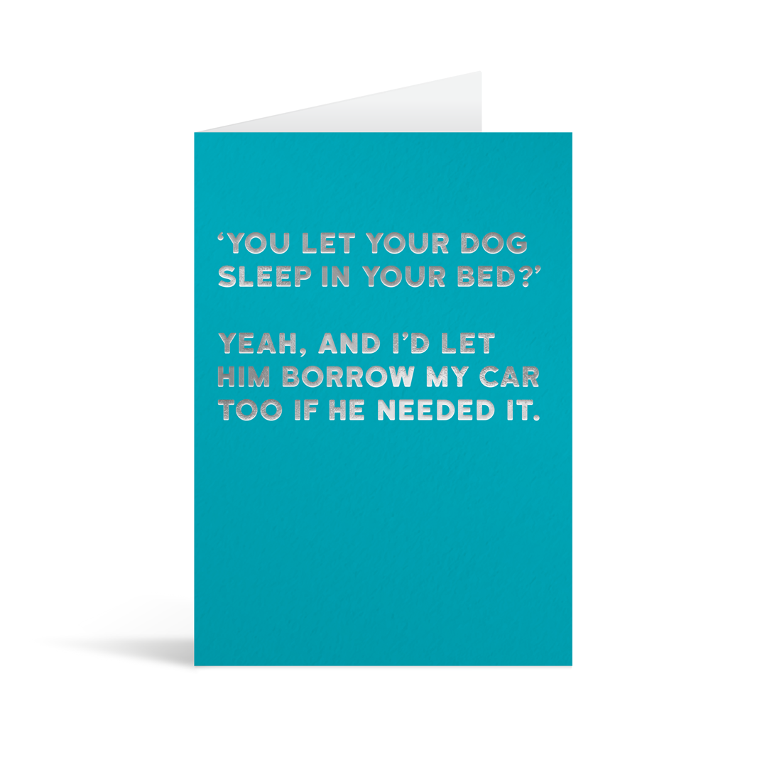 Bright blue card with silver foiled text saying: "'You let your dog sleep in your bed?' yeah and I'd let him borrow my car too if he needed it."