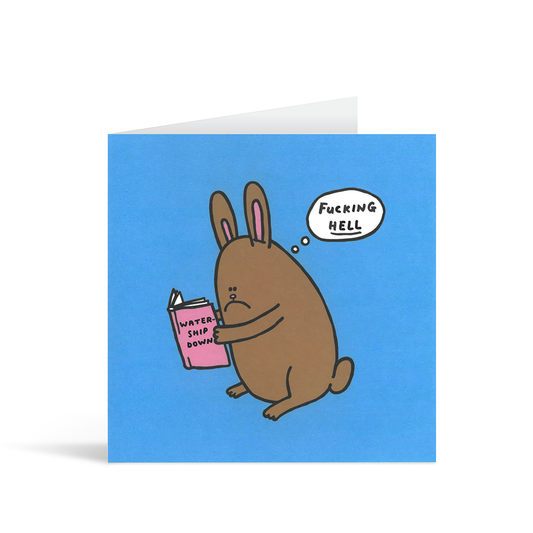 A blue square card with a funny cartoon of a brown rabbit reading the book watership down and a little thought bubble with the words "Fucking hell!!!"