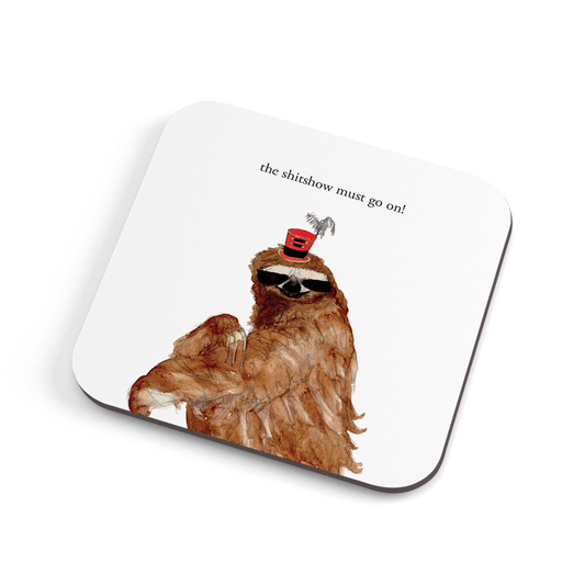 A funny hand illustrated coaster with a a sloth in a tiny tophat, saying "the shitshow must go on!"