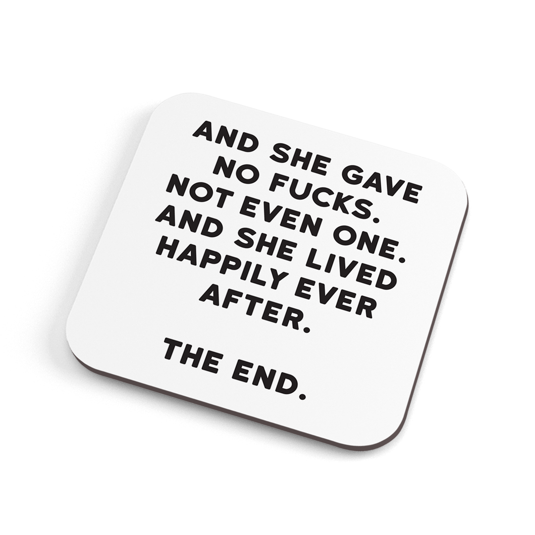 A white funny coaster with black text saying: "And she gave no fucks. Not even one. And she lived happily ever after. The end. "