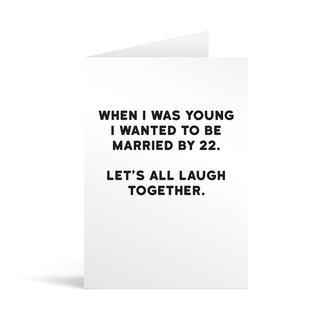 White rectangular card with funny black text saying: "When I was young I wanted to be married by 22. Let's all laugh together."