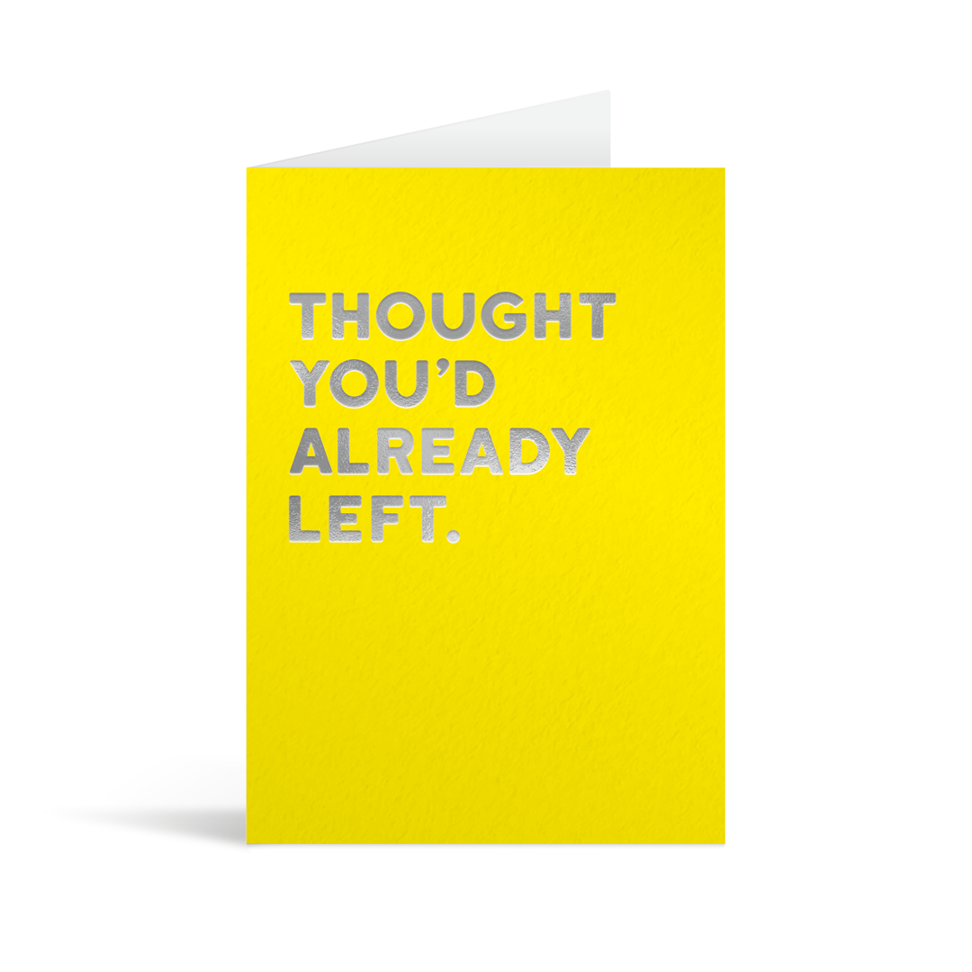 Yellow rectangular card with silver foiled text saying "Thought you'd already left." 