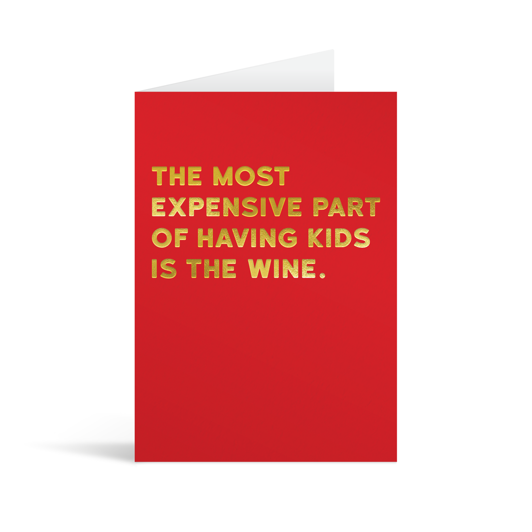 Bright red rectangular card with funny gold foiled text saying: "The most expensive part of having kids is the wine."