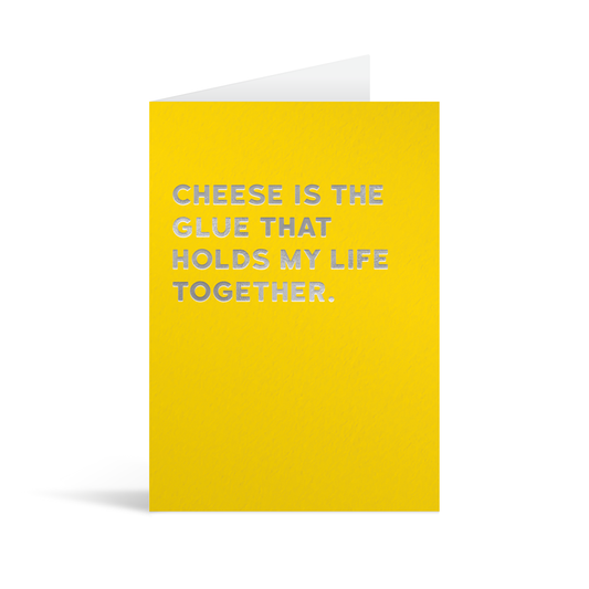 Yellow card with silver foiled text that reads "Cheese is the glue that holds my life together"