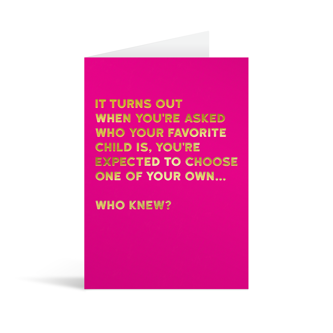 Bright pink rectangular card with gold foiled text saying: "It turns out when you're asked who your favorite child is, you're expected to choose one of your own… who knew?"