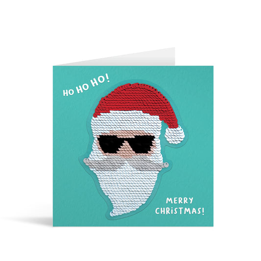 Blue square greetings card with shiny reversible sequin santa patch and fun, free-flowing text that reads "Ho Ho Ho! Merry Christmas!"