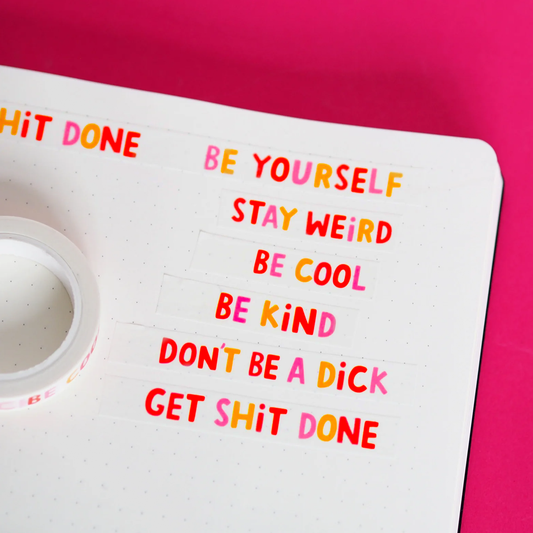 Six strips of multicoloured washi tape saying "Be yourself, stay weird, be cool, be kind, don't be a dick, get shit done." stuck on dotted paper on a red background.