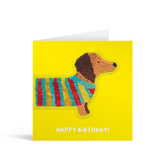 Yellow square greetings card with colourful reversible sequin sausage dog patch and fun, free-flowing text that reads "Happy Birthday!"