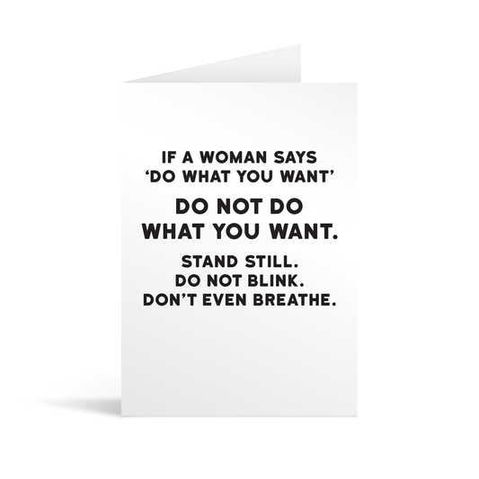 White rectangular card with black text saying: "If a woman says 'do what you want' do not do what you want. Stand still. Do not blink. Don't even breathe."