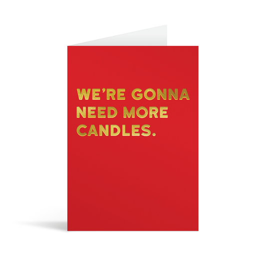 Bright red rectangular card with gold foiled text saying: " We're going to need more candles."