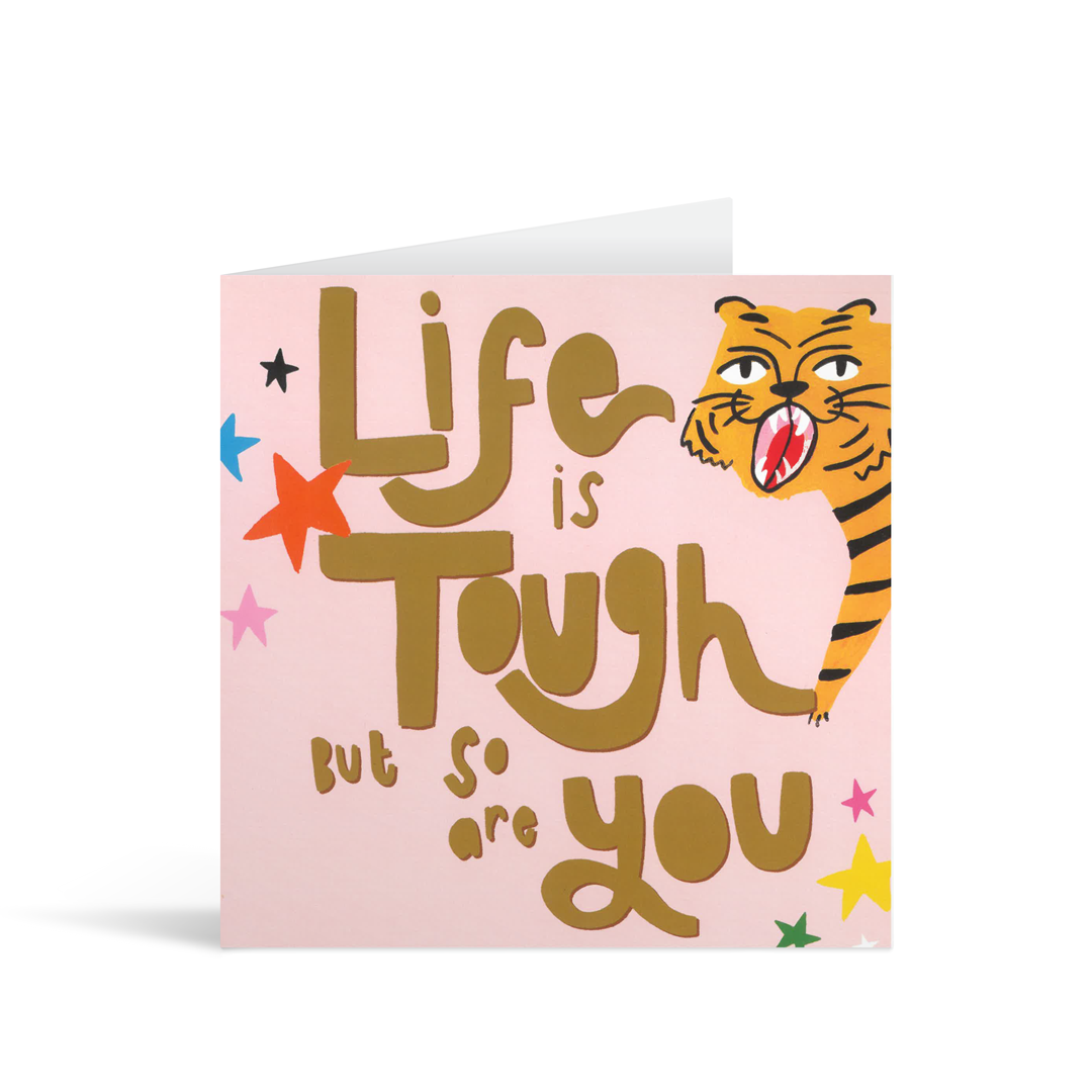 A pale pink card  with hand illustrated colourful stars and a tiger, above the words "Life is tough but so are you" in freestyle fun typeface.