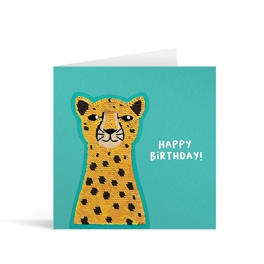 Turquoise square greetings card with shiny golden reversible sequin cheetah patch and fun, free-flowing text that reads "Happy Birthday!"