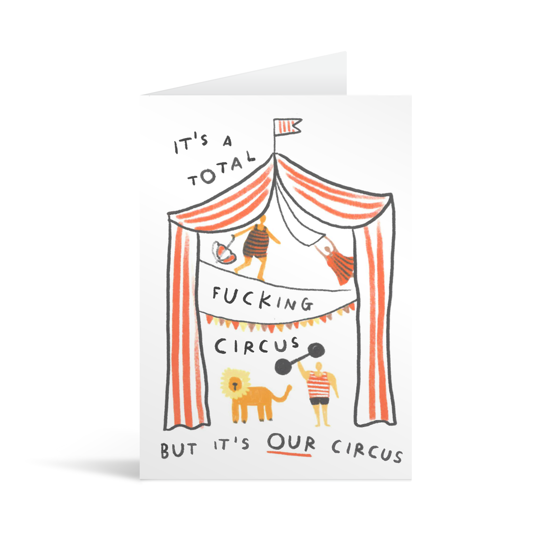 A fun, chilishly charmingly illustrated card of a circus tent, acrobats and a lion, with the words "It's a total fucking circus but it's OUR circus"