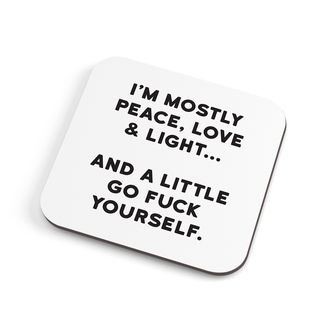 A white funny coaster with black text saying: "I'm mostly peace, love & light… and a little go fuck yourself."